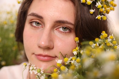 Photo of Portrait of beautiful woman with chamomile flowers, closeup