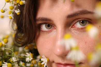 Photo of Portrait of beautiful woman with chamomile flowers, closeup