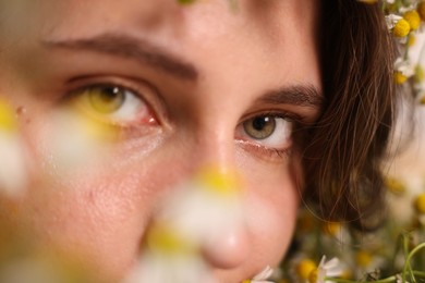 Photo of Portrait of beautiful woman with chamomile flowers, closeup