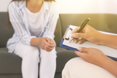 Image of Psychologist working with woman in office, closeup
