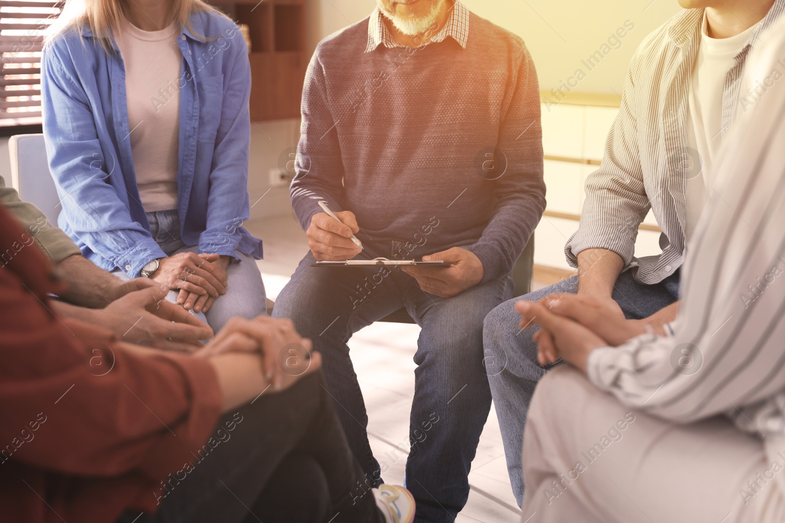 Psychologist conducting group psychotherapy session indoors, closeup Image of Psychologist conducting group psychotherapy session indoors, closeup