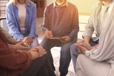 Image of Psychologist conducting group psychotherapy session indoors, closeup