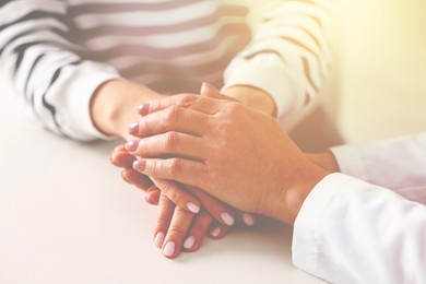Image of Psychologist supporting client during therapy indoors, closeup