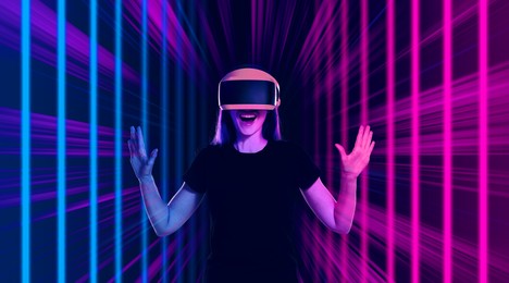 Image of Woman using virtual reality headset. Cyberspace in neon colors