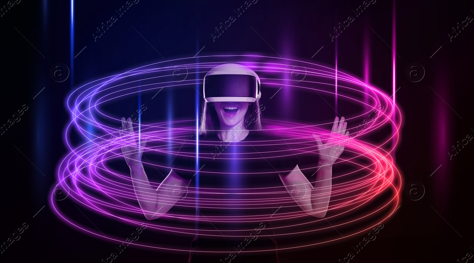 Woman using virtual reality headset on black background. Bright neon lines around her Image of Woman using virtual reality headset on black background. Bright neon lines around her