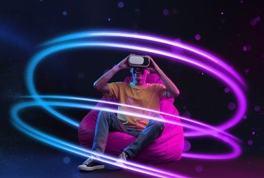 Image of Man using virtual reality headset on bean bag chair against black background. Bright neon lines around him