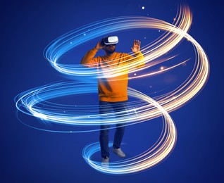 Image of Man using virtual reality headset on blue background. Bright neon lines around him