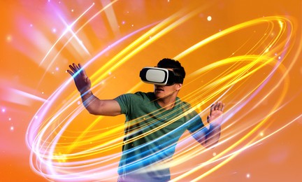 Image of Man using virtual reality headset on orange background. Bright neon lines around him