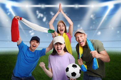 Image of Excited football fans with flags on stadium