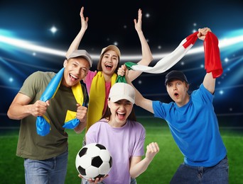 Image of Excited football fans with flags on stadium