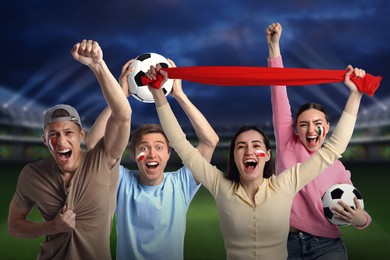 Image of Excited football fans with flags painted on their faces at stadium