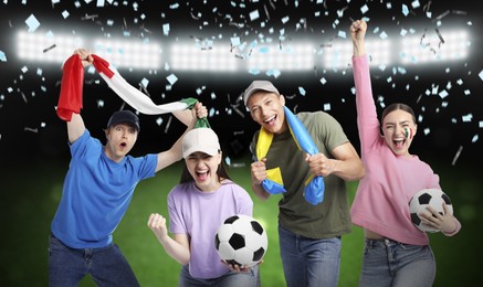 Image of Excited football fans under falling confetti at stadium
