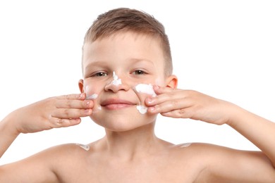 Photo of Little boy applying sun protection cream onto his skin on white background
