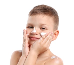 Photo of Little boy applying sun protection cream onto his skin on white background