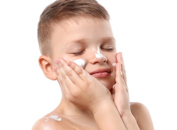 Photo of Little boy applying sun protection cream onto his skin on white background