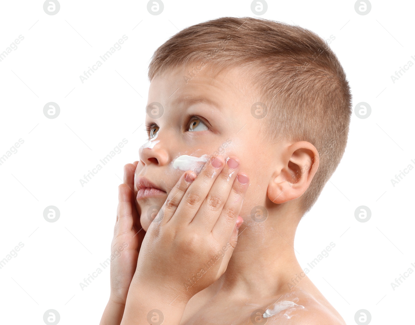 Little boy applying sun protection cream onto his skin on white background Photo of Little boy applying sun protection cream onto his skin on white background