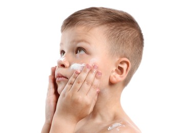 Photo of Little boy applying sun protection cream onto his skin on white background