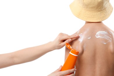 Photo of Mother applying sun protection cream onto her son's skin on white background, closeup