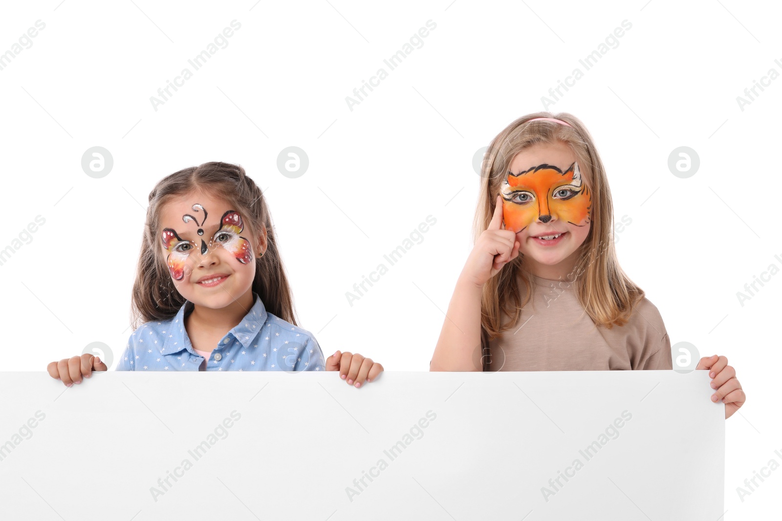 Cute girls with colorful face paintings and blank banner on white background. Space for text Photo of Cute girls with colorful face paintings and blank banner on white background. Space for text