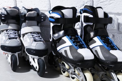 Photo of Roller skates on grey marble table near white brick wall, closeup
