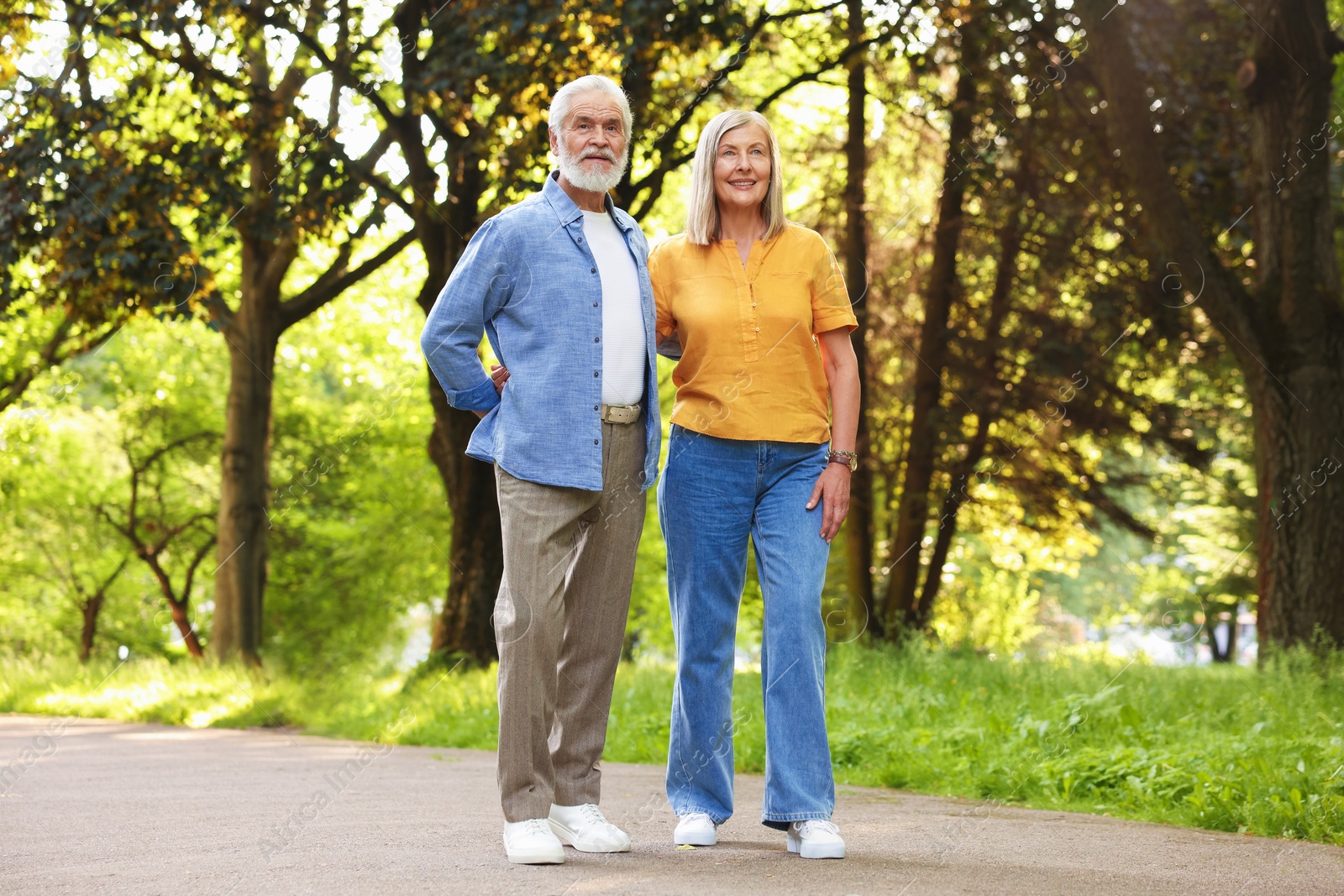 Lovely senior couple walking together in park Photo of Lovely senior couple walking together in park