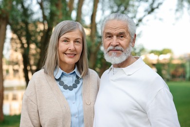 Photo of Lovely senior couple walking together in park
