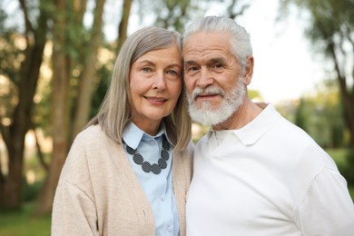 Photo of Lovely senior couple walking together in park