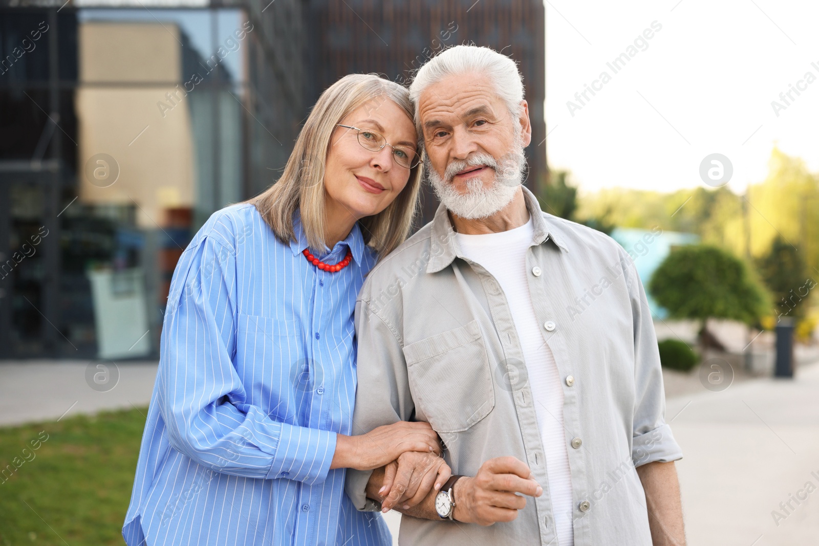 Lovely senior couple walking together in park Photo of Lovely senior couple walking together in park