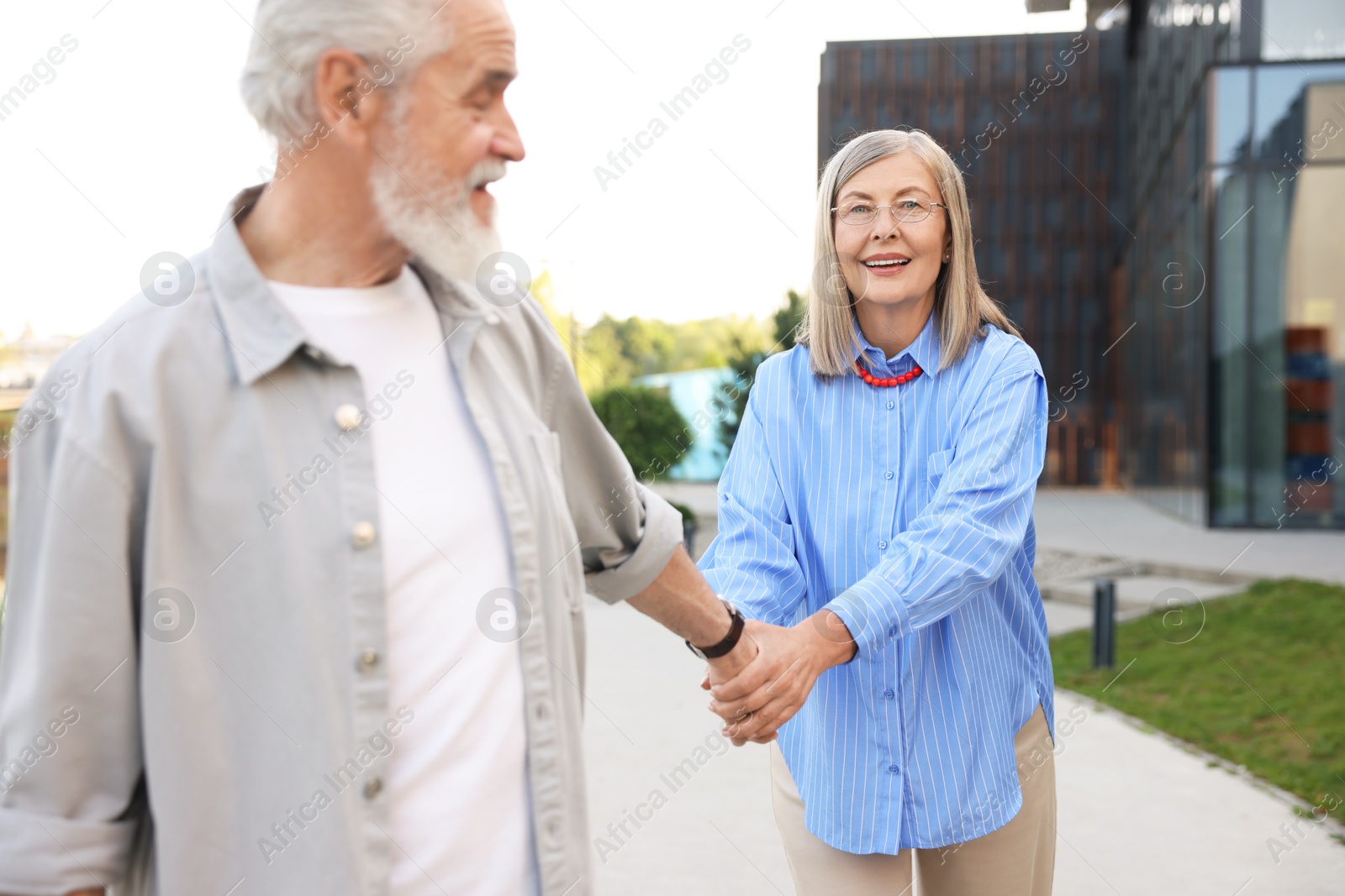 Lovely senior couple walking together in park Photo of Lovely senior couple walking together in park