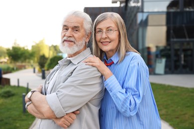 Photo of Lovely senior couple walking together in park