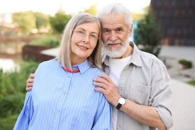 Photo of Lovely senior couple walking together in park