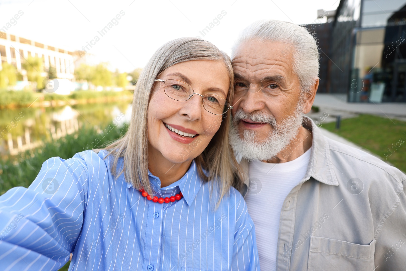 Lovely senior couple walking taking selfie in park Photo of Lovely senior couple walking taking selfie in park