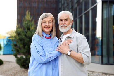 Photo of Lovely senior couple walking together in park