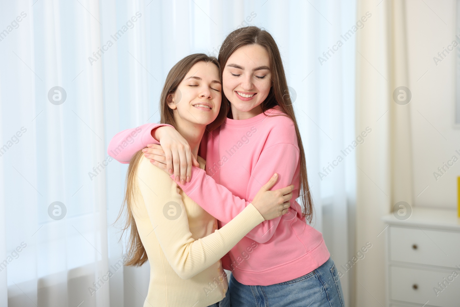 Happy friends hugging each other at home Photo of Happy friends hugging each other at home