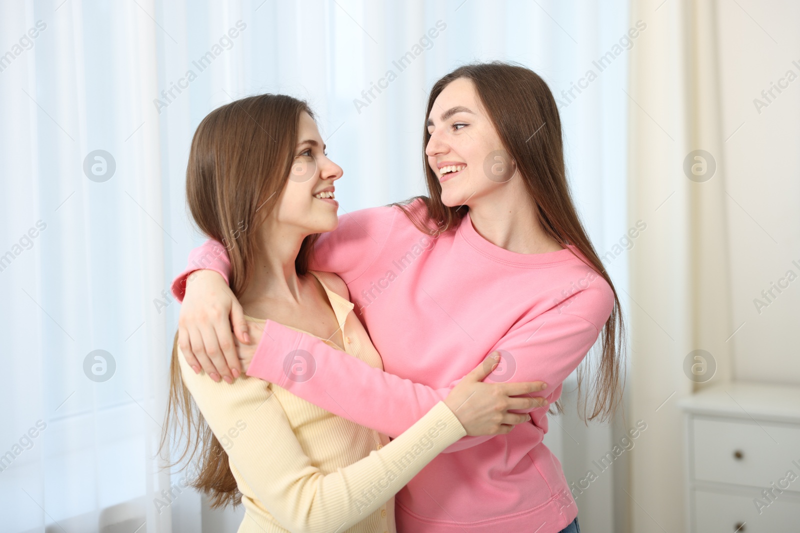 Happy friends hugging each other at home Photo of Happy friends hugging each other at home
