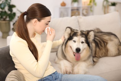 Photo of Woman suffering from allergy with her dog at home