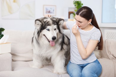 Photo of Woman suffering from allergy with her dog at home