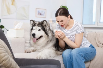 Photo of Woman suffering from allergy with her dog at home