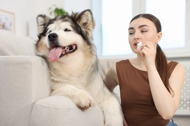 Photo of Woman suffering from allergy with her dog at home