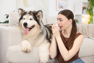 Photo of Woman suffering from allergy with her dog at home