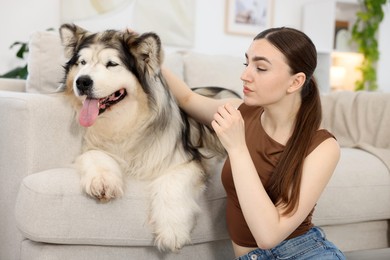 Photo of Woman suffering from allergy with her dog at home