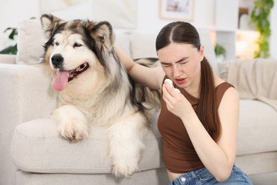 Photo of Woman suffering from allergy with her dog at home