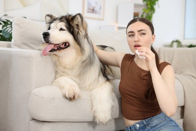 Photo of Woman suffering from allergy with her dog at home