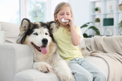 Photo of Girl suffering from allergy with her dog at home