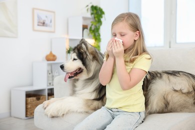 Photo of Girl suffering from allergy with her dog at home