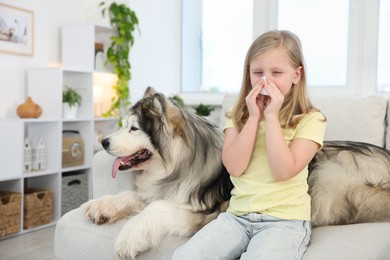 Photo of Girl suffering from allergy with her dog at home