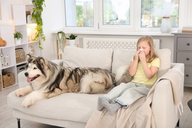 Photo of Girl suffering from allergy with her dog at home