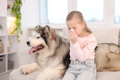Photo of Girl suffering from allergy with her dog at home
