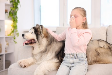 Photo of Girl suffering from allergy with her dog at home