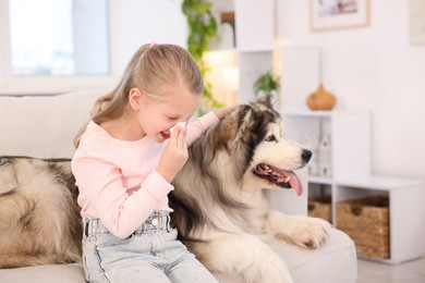 Photo of Girl suffering from allergy with her dog at home